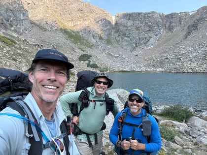 Jesse Dunlap backpacking near Leadville, Colorado with Peacetrain Guides at an alpine lake