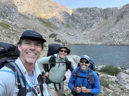 Jesse Dunlap backpacking near Leadville, Colorado with Peacetrain Guides at an alpine lake