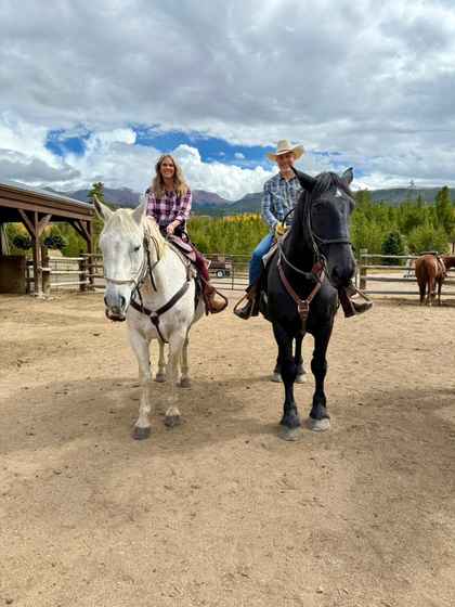 Jesse and Lori Dunlap horseback riding at Devil's Thumb Ranch in Colorado during fall